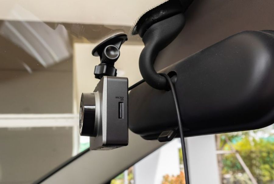 Car dashcam mounted with adhesive